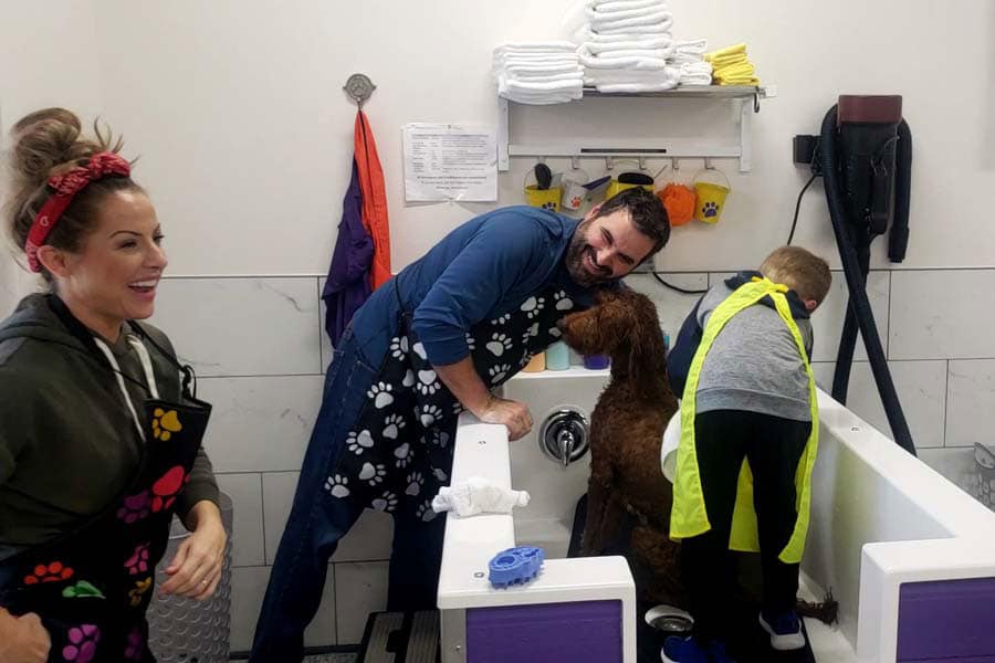 A boy washing his dog in the self-service dog wash